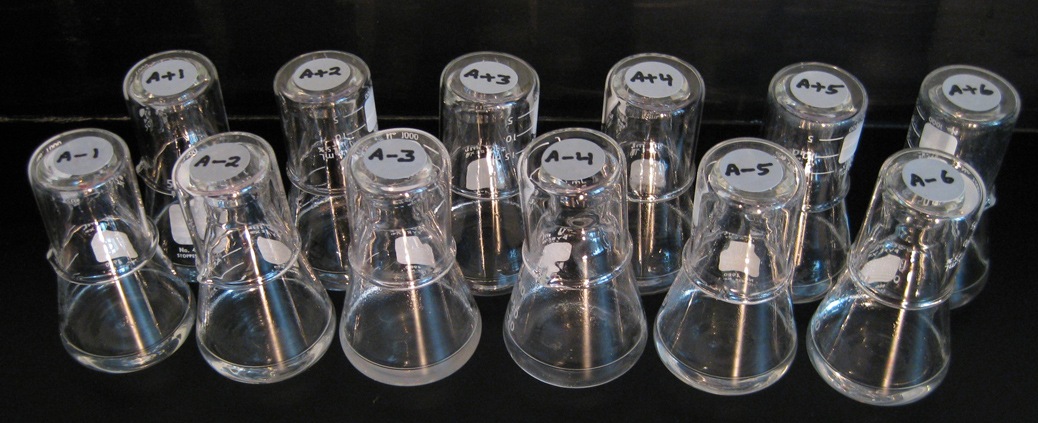 clear vials against a black background.