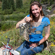 Lauren Koenig holding a mammal in a trap.