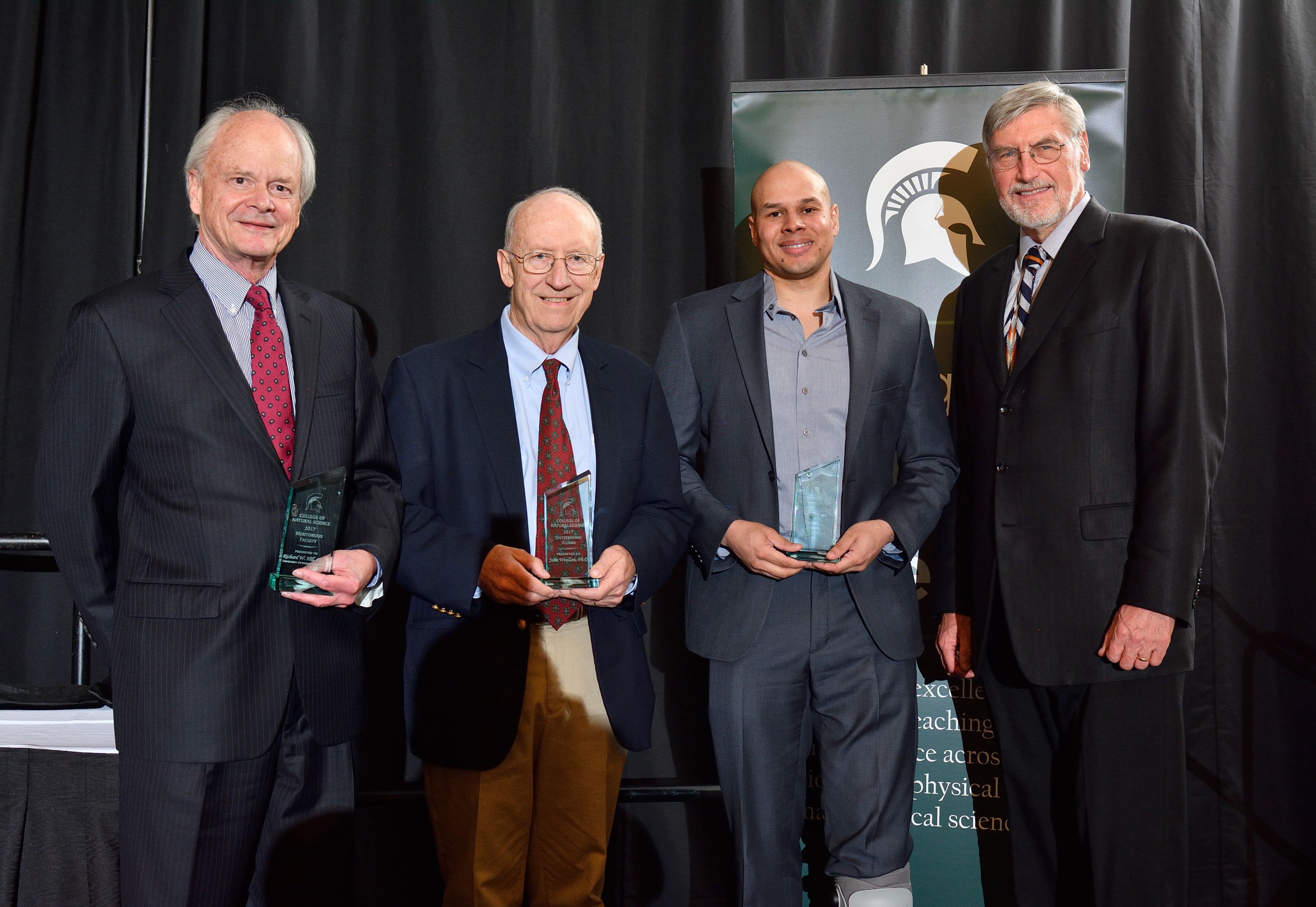 (L to R): Richard Hill, Meritorious Faculty Award winner; John Woolham, Outstanding Alumni Award winner; and Jason Pratt, Recent Alumni Award winner, pose with NatSci Dean R. James Kirkpatrick following this year's NatSci Alumni Awards dinner.