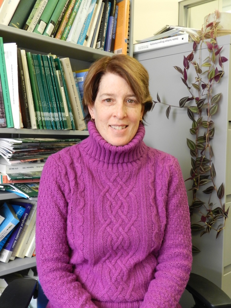 Catherine Lindell sitting in front of a bookshelf.