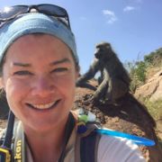 Eila Roberts with a wild primate standing in the background