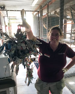 Whitney Massie holding an enrichment item made for a zoo animal