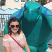 Heather Seaman standing next to a turtle statue